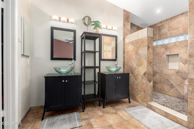 bathroom with vanity and a tile shower