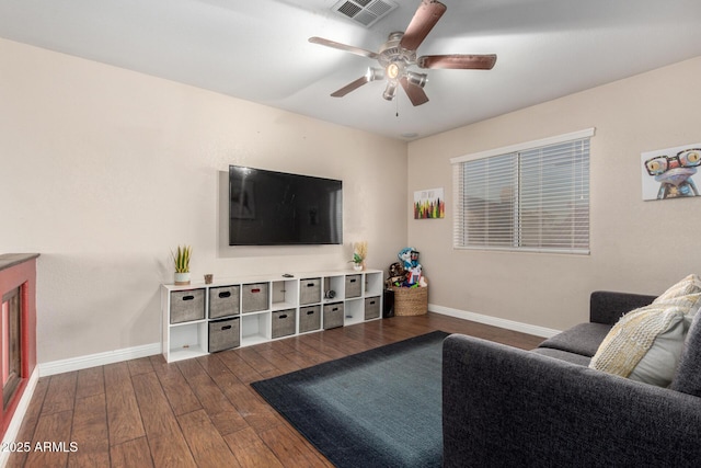 living room featuring ceiling fan and hardwood / wood-style floors