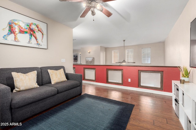 living room featuring dark hardwood / wood-style flooring and ceiling fan