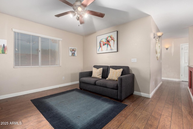 living room featuring ceiling fan and dark hardwood / wood-style floors