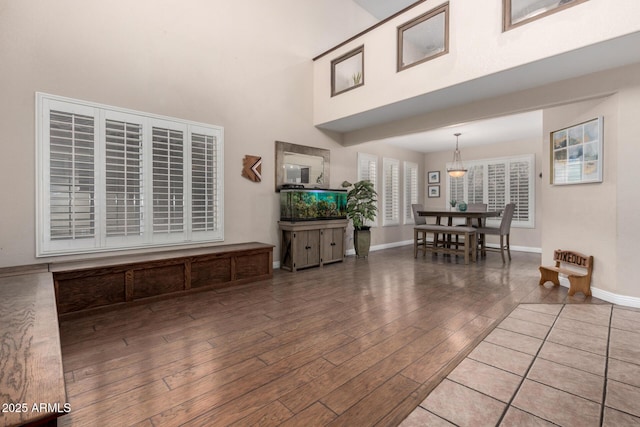 living room with a towering ceiling and hardwood / wood-style floors