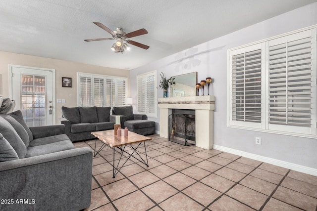 tiled living room with a textured ceiling and ceiling fan