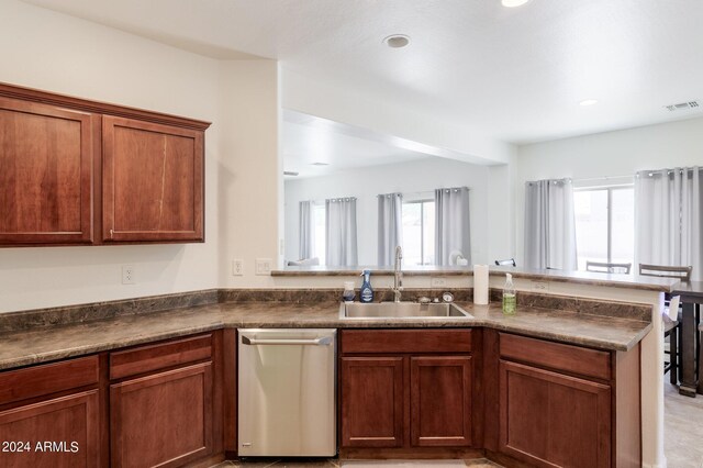 kitchen with kitchen peninsula, dishwasher, and sink