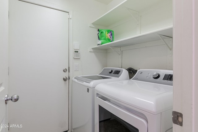 laundry room featuring washing machine and clothes dryer