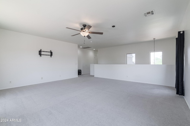 spare room with ceiling fan and carpet