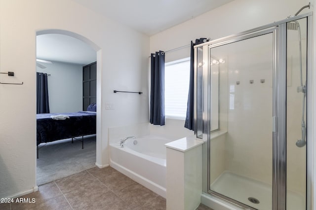 bathroom with tile patterned floors and shower with separate bathtub