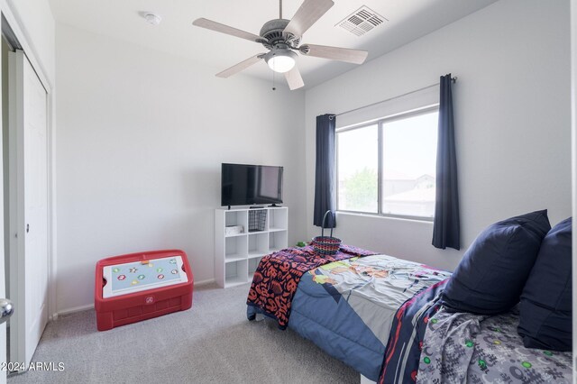 bedroom featuring carpet flooring, a closet, and ceiling fan