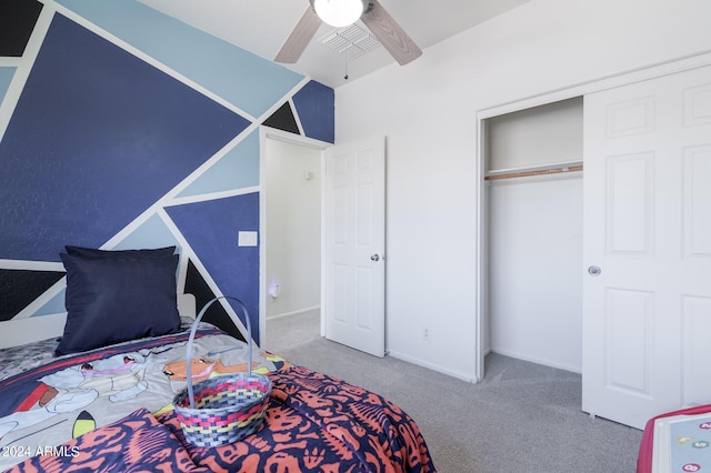 carpeted bedroom with ceiling fan and a closet