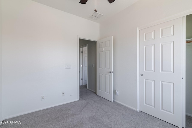 unfurnished bedroom with light carpet and ceiling fan