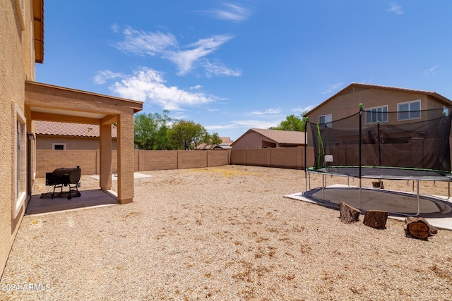 view of yard with a trampoline