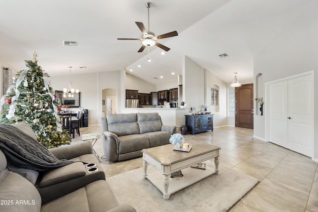 living room with arched walkways, high vaulted ceiling, ceiling fan with notable chandelier, and visible vents