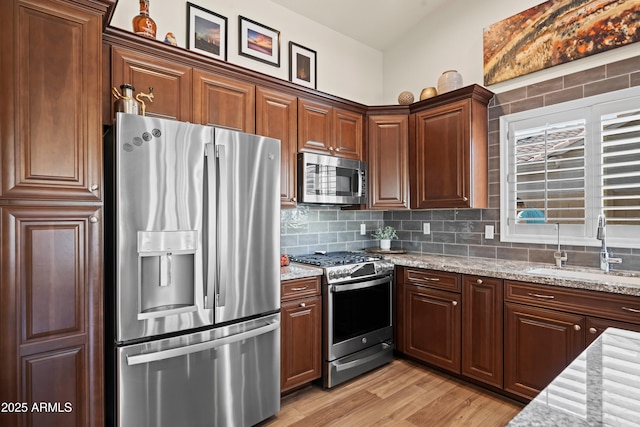 4029 N 160th Dr, Goodyear, AZ 85395 - kitchen featuring appliances with stainless steel finishes, decorative backsplash, and light stone counters