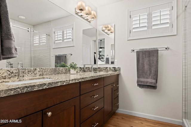 4029 N 160th Dr, Goodyear, AZ 85395 - bathroom with double vanity, wood finished floors, and a stall shower