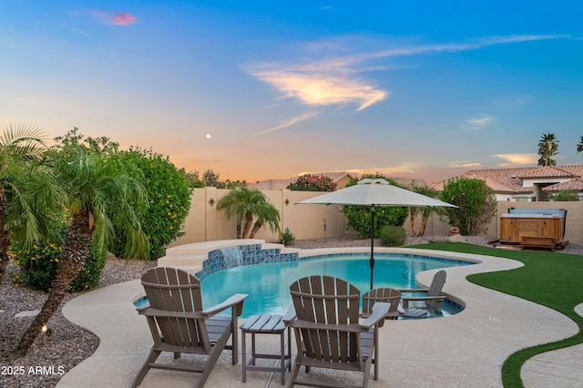 4029 N 160th Dr, Goodyear, AZ 85395 - pool at dusk featuring a hot tub, a fenced backyard, and a patio