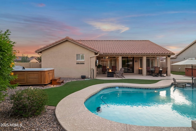 4029 N 160th Dr, Goodyear, AZ 85395 - rear view of house featuring a hot tub, a patio, a tiled roof, and stucco siding