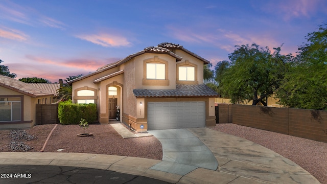 mediterranean / spanish house featuring a garage