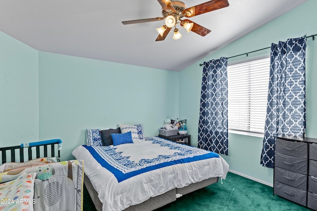 bedroom with dark colored carpet, ceiling fan, and lofted ceiling