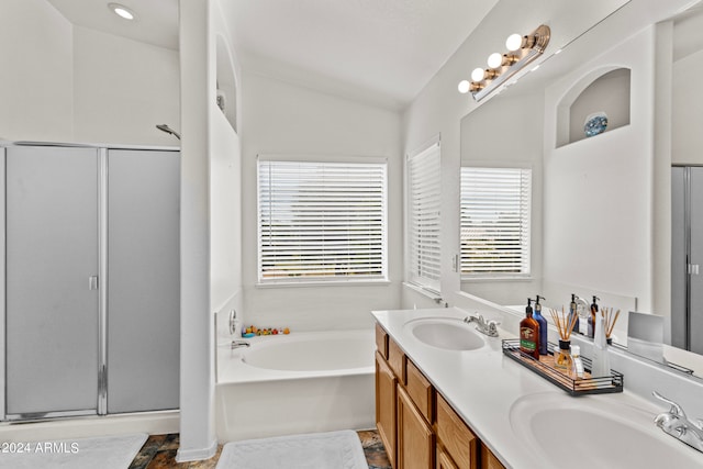 bathroom with vanity, independent shower and bath, and lofted ceiling