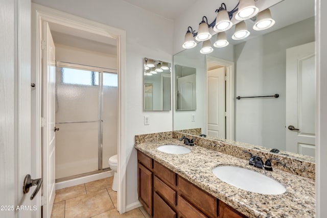 bathroom with toilet, tile patterned floors, walk in shower, and vanity