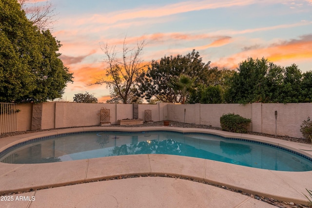 view of pool at dusk