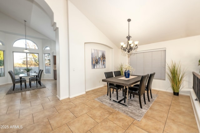 tiled dining area featuring high vaulted ceiling and a notable chandelier