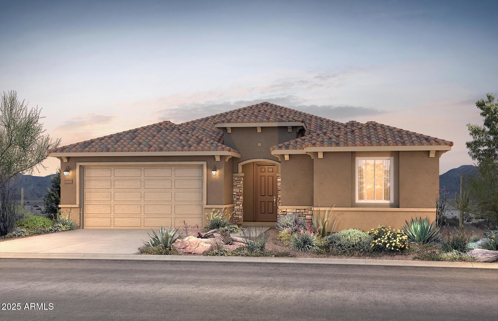 view of front of property featuring a garage, concrete driveway, a tiled roof, and stucco siding