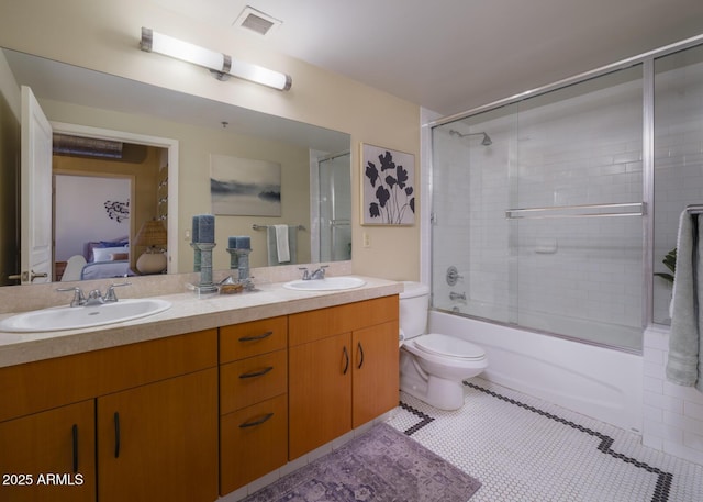 114 W Adams St Unit 907, Phoenix, AZ 85003 - ensuite bathroom featuring double vanity, tile patterned flooring, toilet, and shower / bath combination with glass door