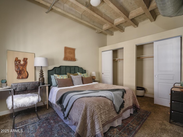 114 W Adams St Unit 907, Phoenix, AZ 85003 - carpeted bedroom featuring two closets and beamed ceiling