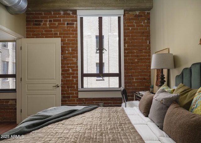 114 W Adams St Unit 907, Phoenix, AZ 85003 - bedroom with brick wall and wood finished floors