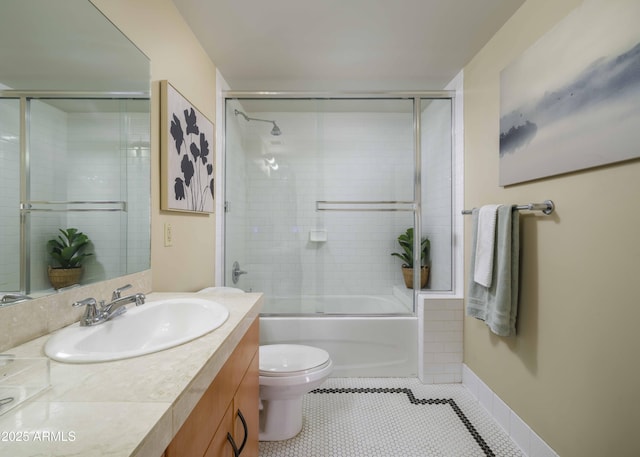 114 W Adams St Unit 907, Phoenix, AZ 85003 - bathroom with vanity, toilet, bath / shower combo with glass door, tile patterned floors, and baseboards