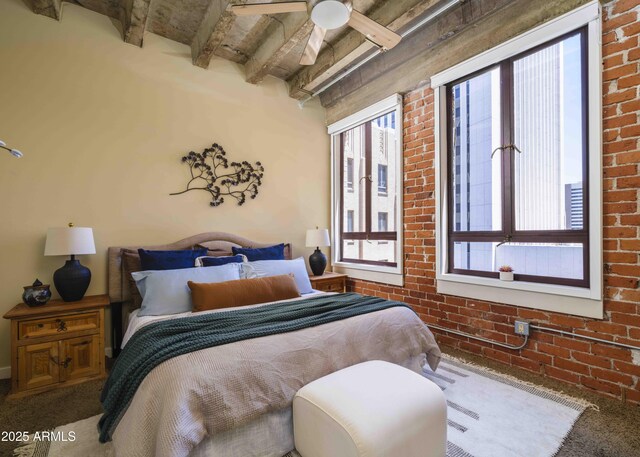 114 W Adams St Unit 907, Phoenix, AZ 85003 - bedroom featuring brick wall, beam ceiling, and carpet
