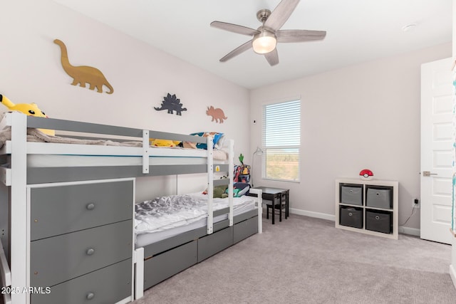 bedroom with light carpet, baseboards, and a ceiling fan