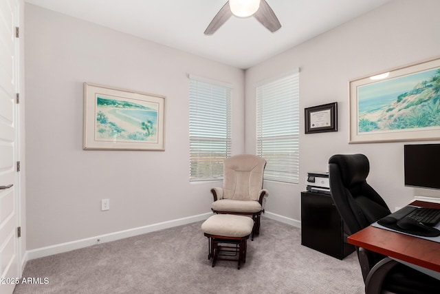 home office with light colored carpet, baseboards, and a ceiling fan