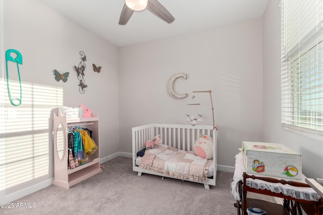 carpeted bedroom featuring baseboards and a ceiling fan