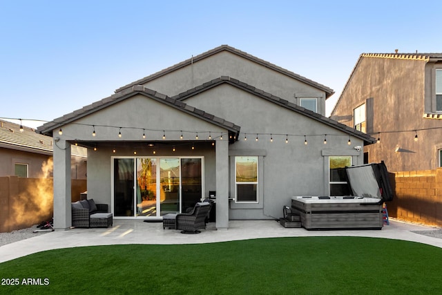 rear view of property with a patio area, a yard, a fenced backyard, and stucco siding