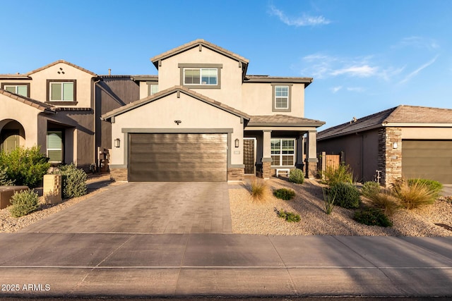 view of front of property featuring a porch, driveway, stucco siding, and a tiled roof
