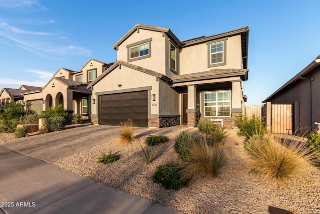view of front of property with stucco siding, fence, stone siding, a tile roof, and concrete driveway