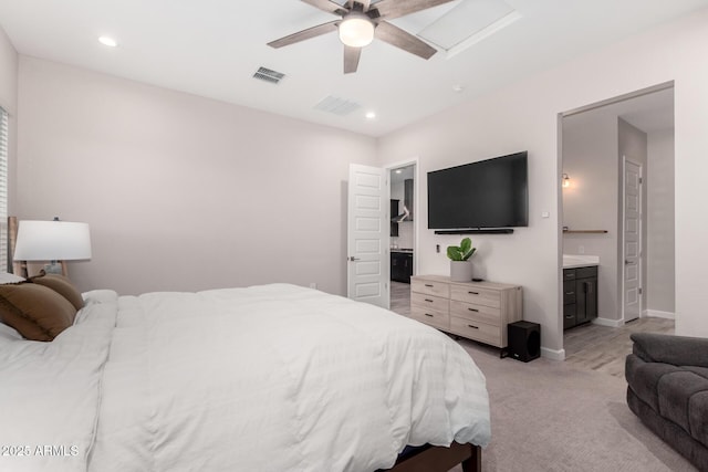 bedroom featuring visible vents, recessed lighting, ensuite bath, and light carpet
