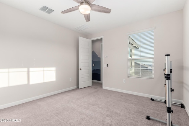 exercise room with plenty of natural light, visible vents, carpet floors, and ceiling fan