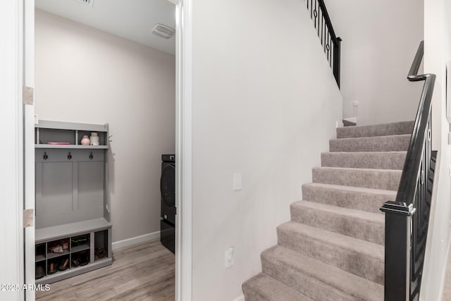 stairway with baseboards and wood finished floors