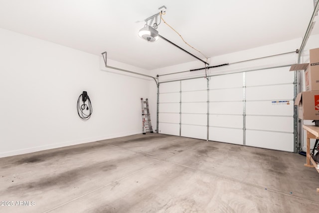 garage featuring a garage door opener and baseboards