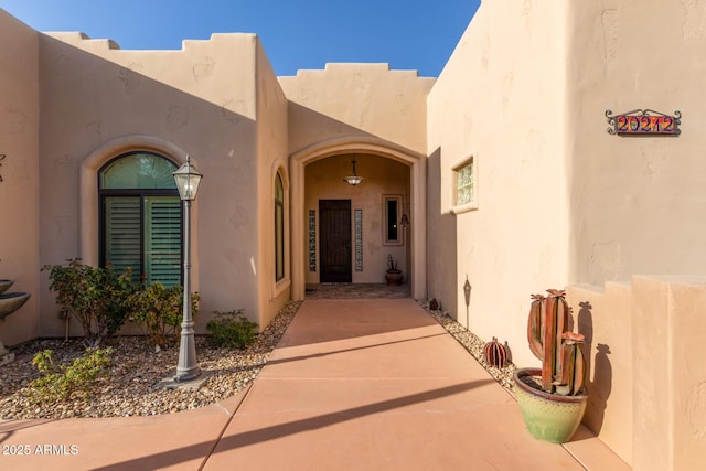 property entrance with stucco siding