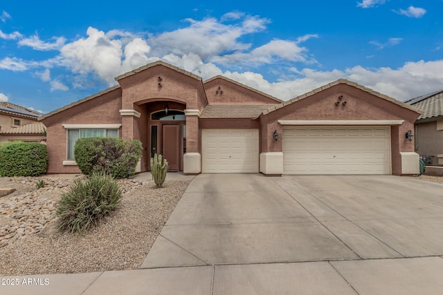 1934 W Morning Vista Ln, Phoenix, AZ 85085 - view of front facade with a tiled roof, driveway, a garage, and stucco siding