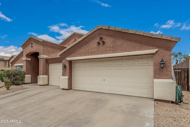 1934 W Morning Vista Ln, Phoenix, AZ 85085 - view of front of house featuring an attached garage, fence, driveway, and stucco siding