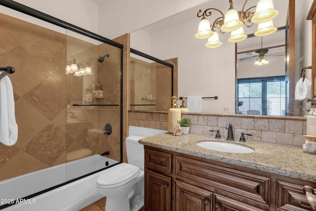 full bath featuring ceiling fan, toilet, shower / bath combination with glass door, vanity, and backsplash