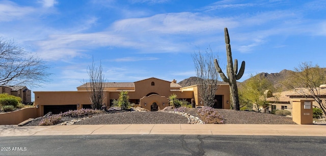 pueblo-style home featuring stucco siding