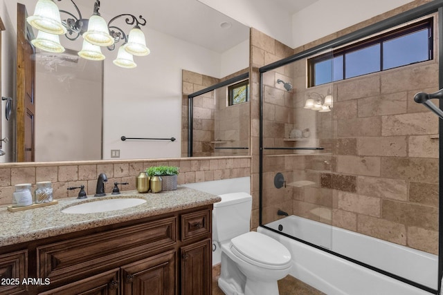 bathroom featuring tile walls, backsplash, toilet, vanity, and a chandelier