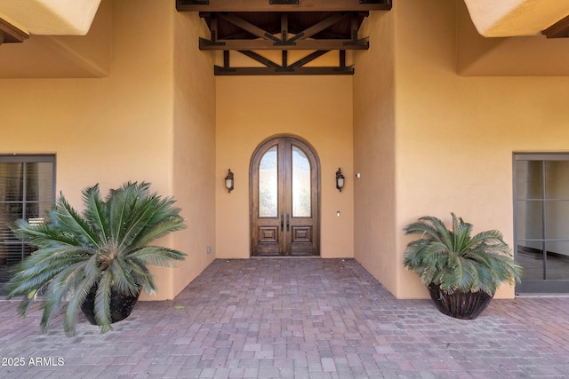 property entrance with french doors and stucco siding