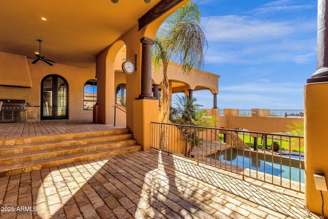 view of patio / terrace featuring french doors, grilling area, a ceiling fan, and a fenced in pool