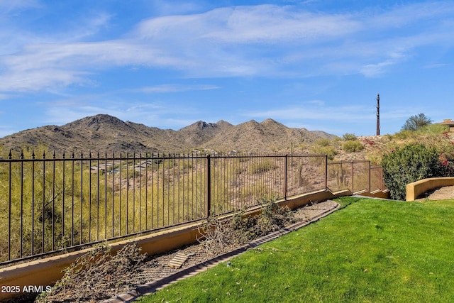 view of yard with a fenced backyard and a mountain view